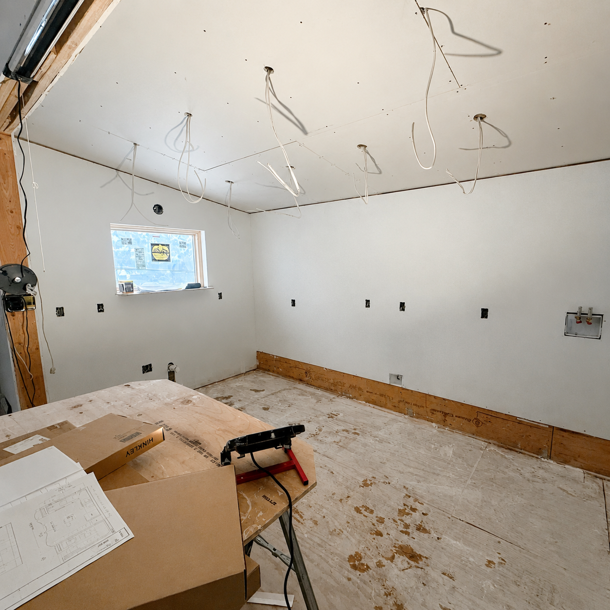 Stripped room with wiring drops left ready for fixtures and finishes — drywall and repair service in Denver