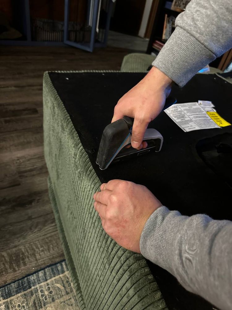Upholstered bed base being fitted together in a bedroom — furniture assembly service in Denver