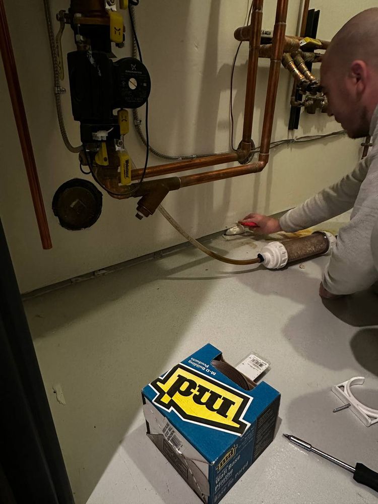 Copper pipework and pump being serviced in a mechanical room — plumbing repair service in Denver