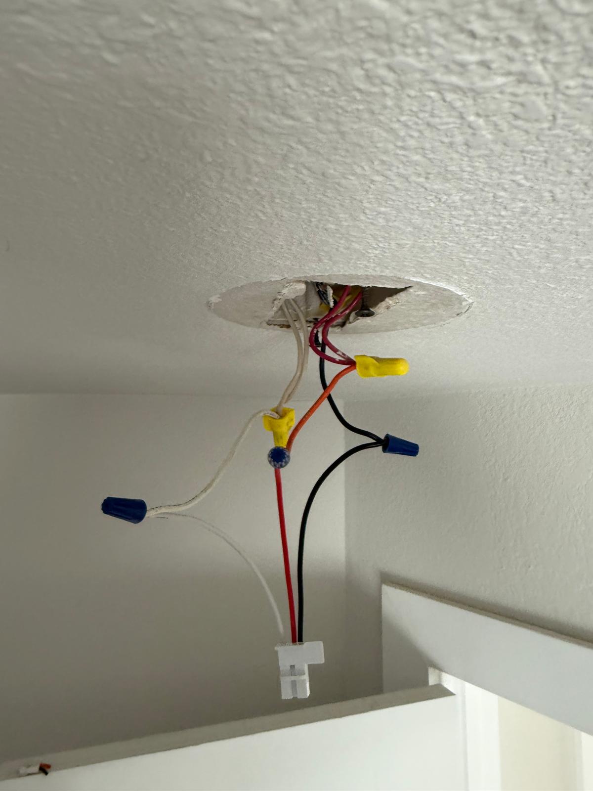 Ceiling fixture wiring connected and tucked back into the box before mounting — fixture installation service in Denver