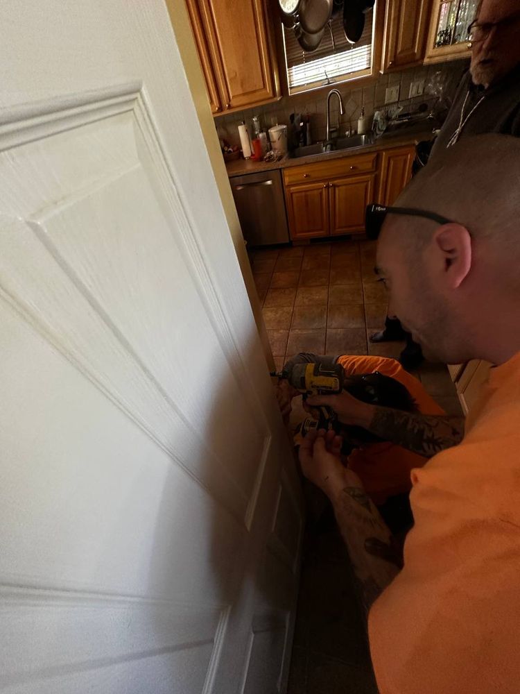 Interior door being planed and adjusted so it closes cleanly — door repair service in Denver
