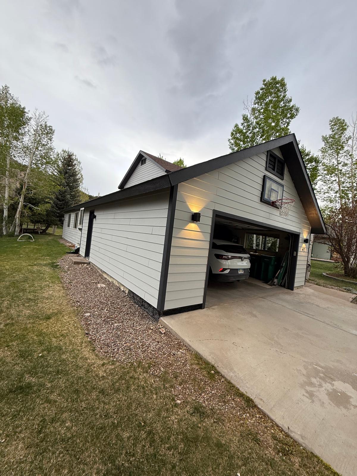 Finished repainted home exterior with attached garage and clean trim lines — exterior painting service in Denver