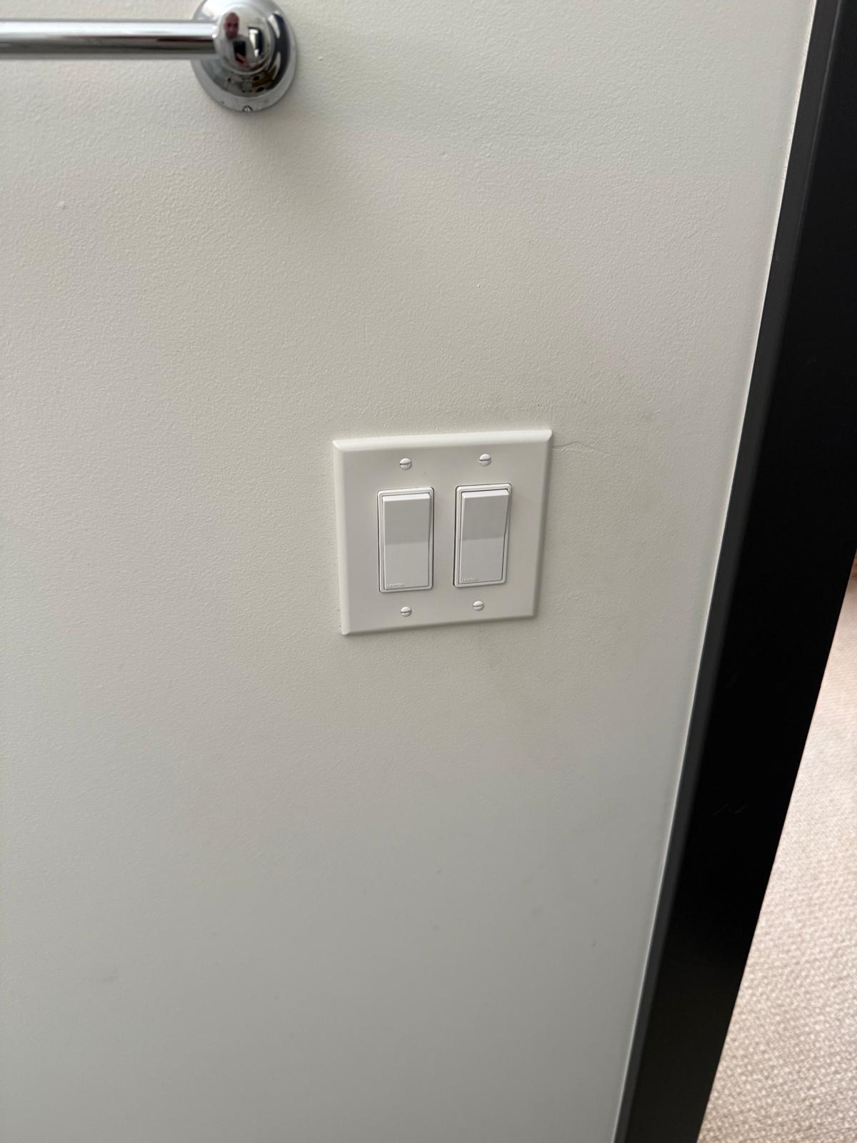 Completed double rocker switch plate finished flush against a painted wall — electrical fixture installation service in Denver
