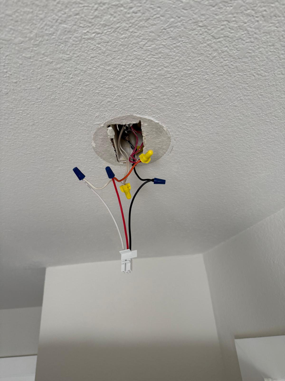 Ceiling box with capped and labelled conductors ready for a new light fitting — fixture installation service in Denver